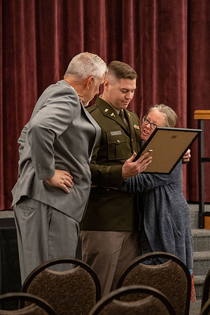 Four graduates from the BYU-Idaho ROTC program gather with the families and have a ceremonial commissioning.