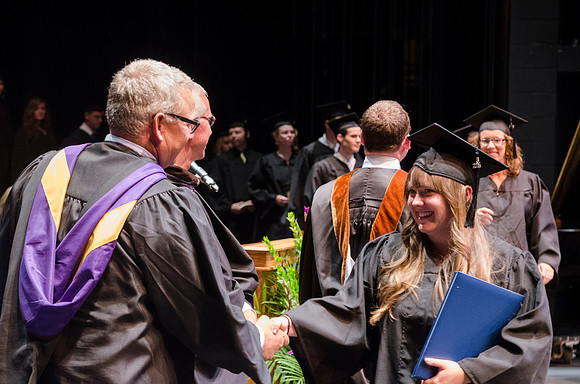 Dean's of the College of Performing and Visual Arts award diplomas to graduates during convocation held in the Snow Building. Photo by Tyler Rickenbach