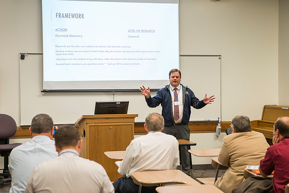 Faculty gather in the Hinckley Building for a conference to learn from their peers. Instructor Craig Whetten