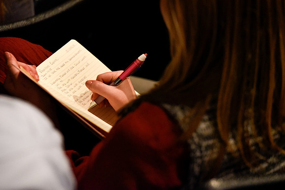 Student taking note at devotional