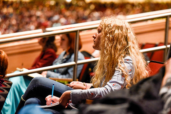 Student taking note at devotional
