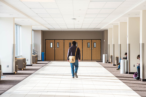 A student walks down the I-Center hallway.