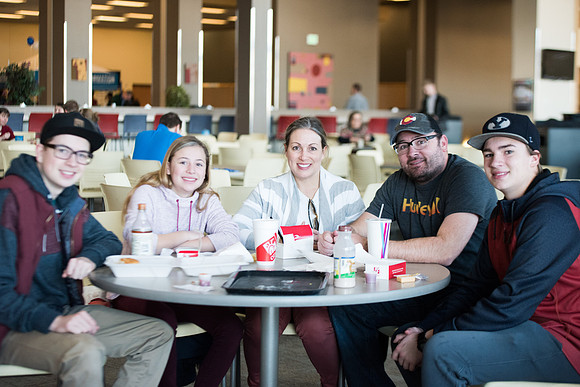New students and their families getting together at the Crossroads enjoying some food. Jan 2018