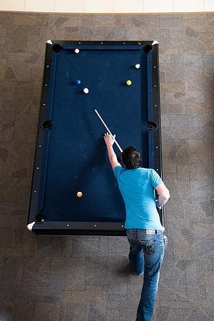 Student playing pool at the Manwarning Center.