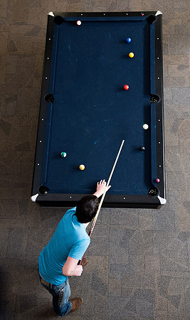 Student playing pool at the Manwarning Center.