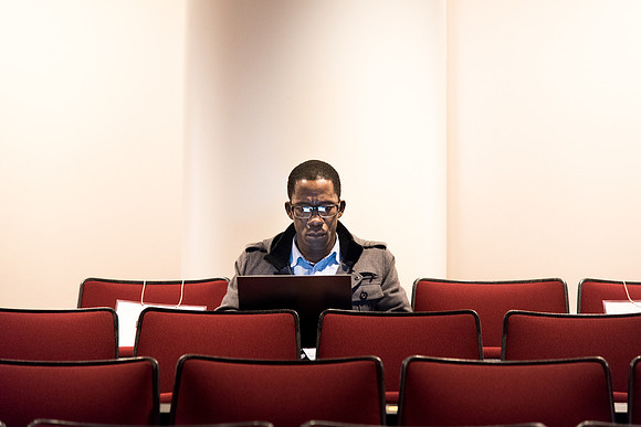 Student studying before the Devotional starts.
