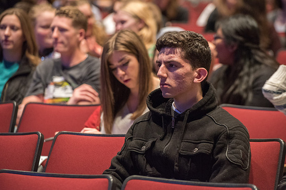 Student listening to the talk at Devotional.