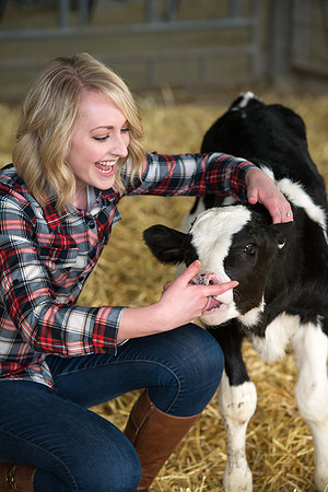 Erica Crabb with a hungry little calf at the Agriculture Science Center.