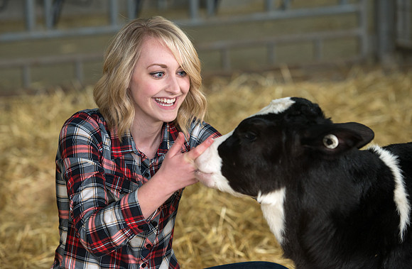 Erica Crabb with a hungry little calf at the Agriculture Science Center.