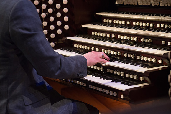 Organist plays prelude music setting the tone for a devotional with Elder Gary Stevenson.