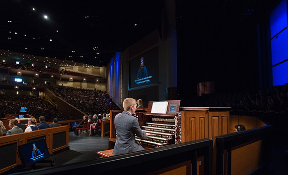 Organist plays opening hymn for devotional.