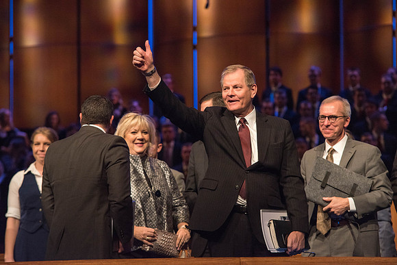 Elder Stevenson waves goodbye at the end of his Devotional talk. Photo by Garrett Blanchard.