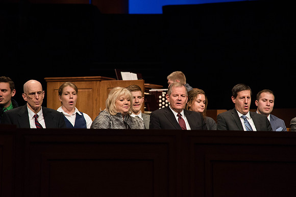 Elder and Sister Stevenson sings a hymn at Devotional, along with the congregation.
