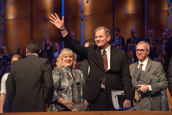 Elder Stevenson waves goodbye at the end of his Devotional talk. Photo by Garrett Blanchard.