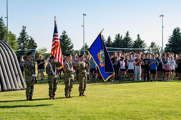 Students gather at the upper field for various 4th of July activities.