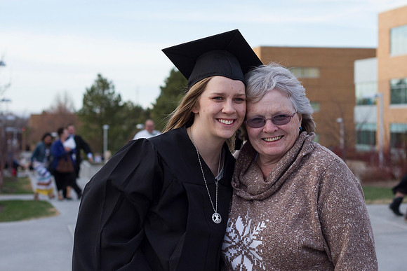 During the 2014 Winter Semester Graduation, a graduate poses with her grandmother outside the BYU-I I-Center.