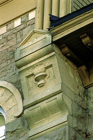 Close-up of the torch and sunburst on the Spori Building