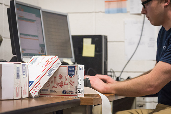 Students work in Mail Services getting packages organized and sent off to Centre Square apartments.