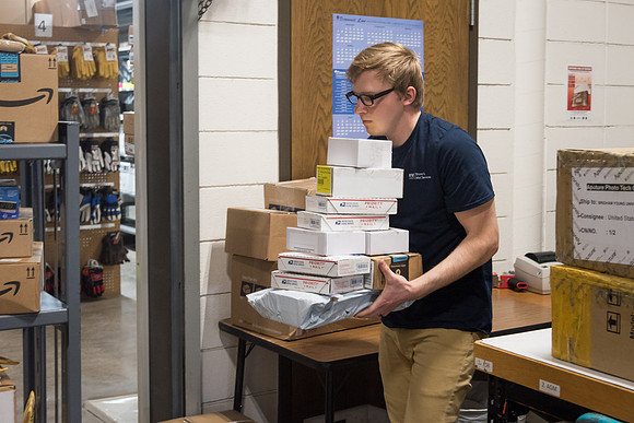 Students work in Mail Services getting packages organized and sent off to Centre Square apartments.