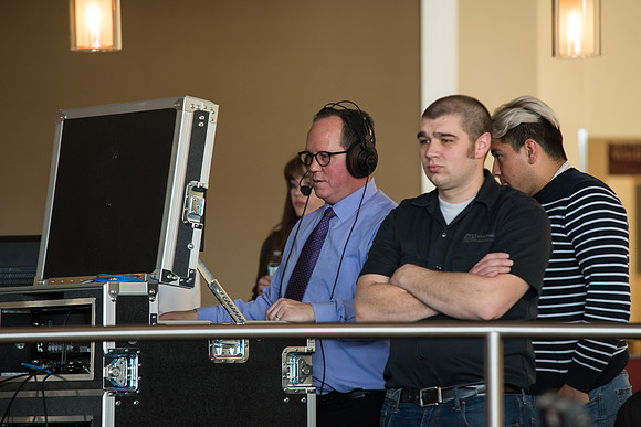 Michael Ballard, Video Production Coordinator, watching the conversation video clips.