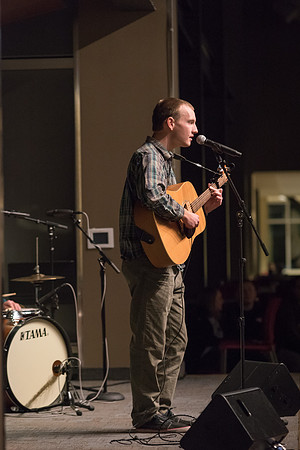 Students perform songs to an audience in the Crossroads at Acoustic Cafe.
