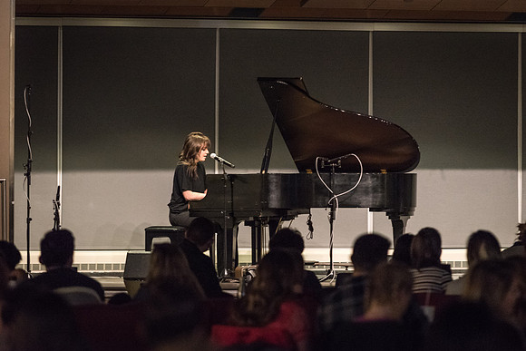 Students perform songs to an audience in the Crossroads at Acoustic Cafe.