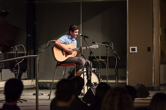 Students perform songs to an audience in the Crossroads at Acoustic Cafe.