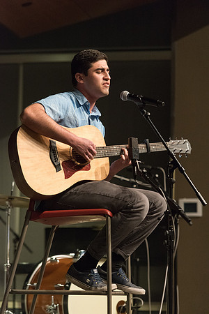 Students perform songs to an audience in the Crossroads at Acoustic Cafe.