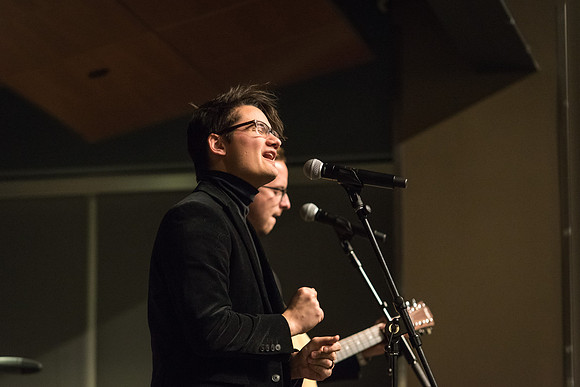 Students perform songs to an audience in the Crossroads at Acoustic Cafe.