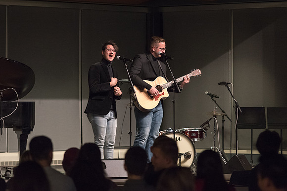 Students perform songs to an audience in the Crossroads at Acoustic Cafe.