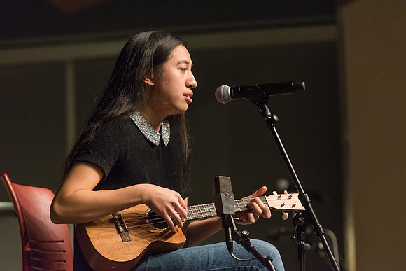 Students perform songs to an audience in the Crossroads at Acoustic Cafe.