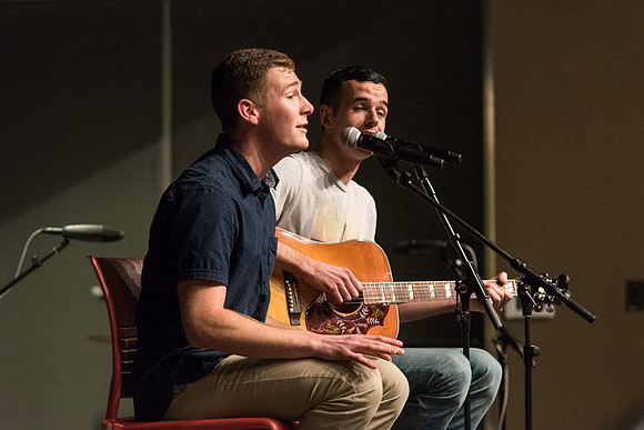 Students perform songs to an audience in the Crossroads at Acoustic Cafe.