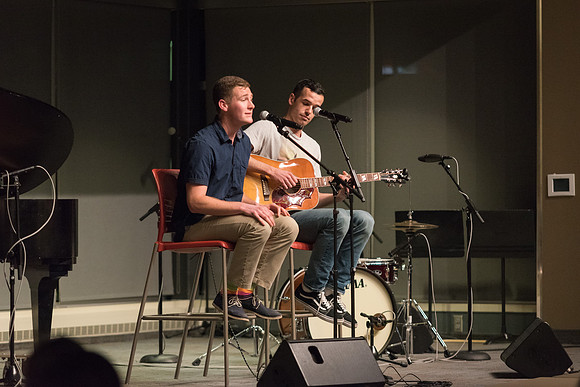 Students perform songs to an audience in the Crossroads at Acoustic Cafe.
