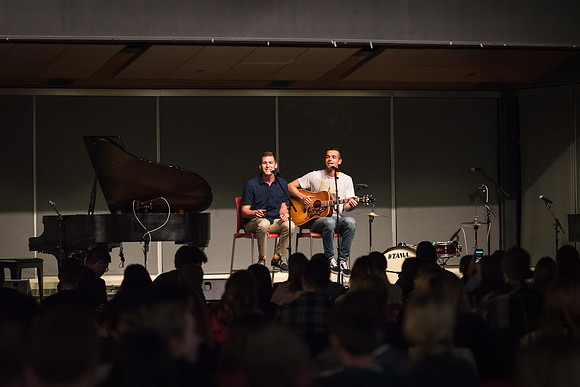Students perform songs to an audience in the Crossroads at Acoustic Cafe.