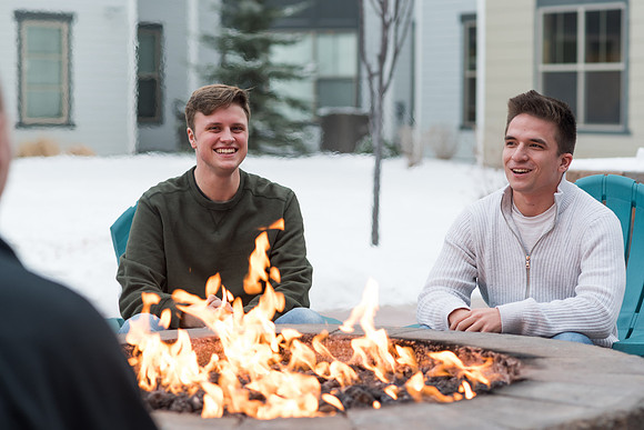 Students enjoy themselves one evening around a fire.