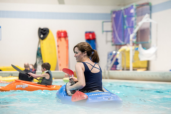 Students for a weekly gathering in the Hart pool to practice kayaking.