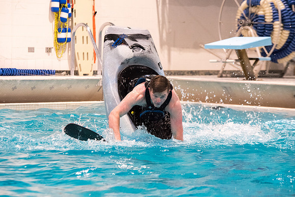 Students for a weekly gathering in the Hart pool to practice kayaking.