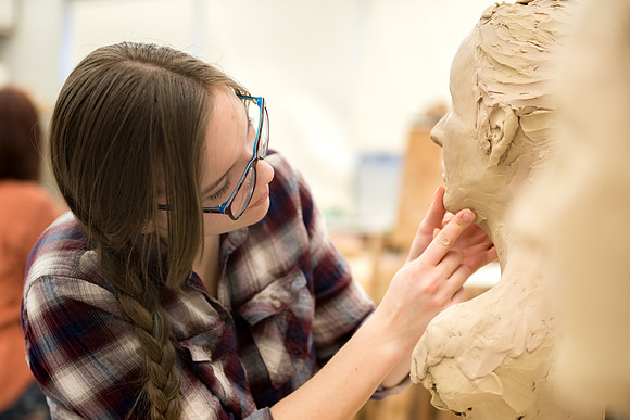 Students making head sculpture at a class taught by Brother Kody Keller