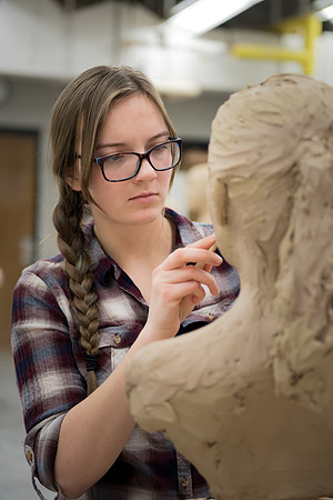 Students making head sculpture at a class taught by Brother Kody Keller