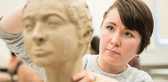 Students making head sculpture at a class taught by Brother Kody Keller