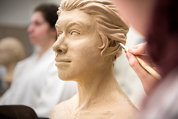 Students making head sculpture at a class taught by Brother Kody Keller