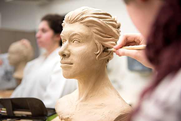 Students making head sculpture at a class taught by Brother Kody Keller