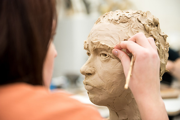 Students making head sculpture at a class taught by Brother Kody Keller