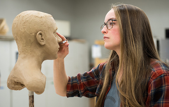 Students making head sculpture at a class taught by Brother Kody Keller