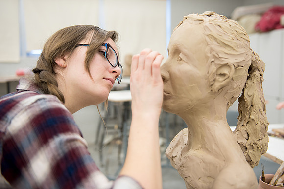 Students making head sculpture at a class taught by Brother Kody Keller