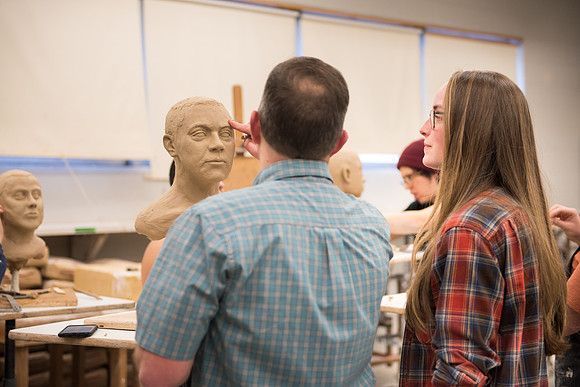 Students making head sculpture at a class taught by Brother Kody Keller