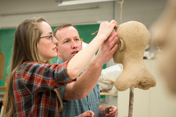Students making head sculpture at a class taught by Brother Kody Keller