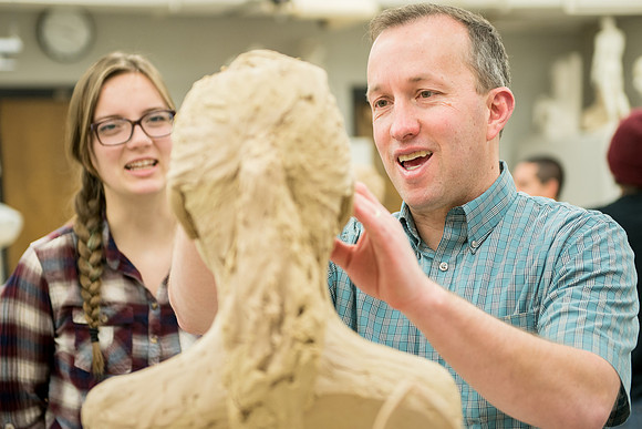 Students making head sculpture at a class taught by Brother Kody Keller