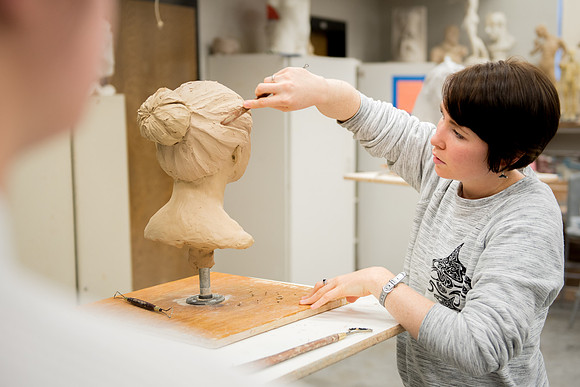 Students making head sculpture at a class taught by Brother Kody Keller