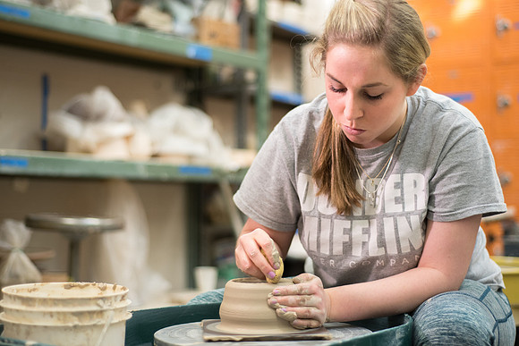 Students work on their clay projects in beginning ceramics class.